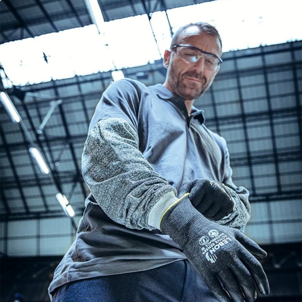Personne dans un entrepot qui porte les gants Le Bon Protection client Numendo